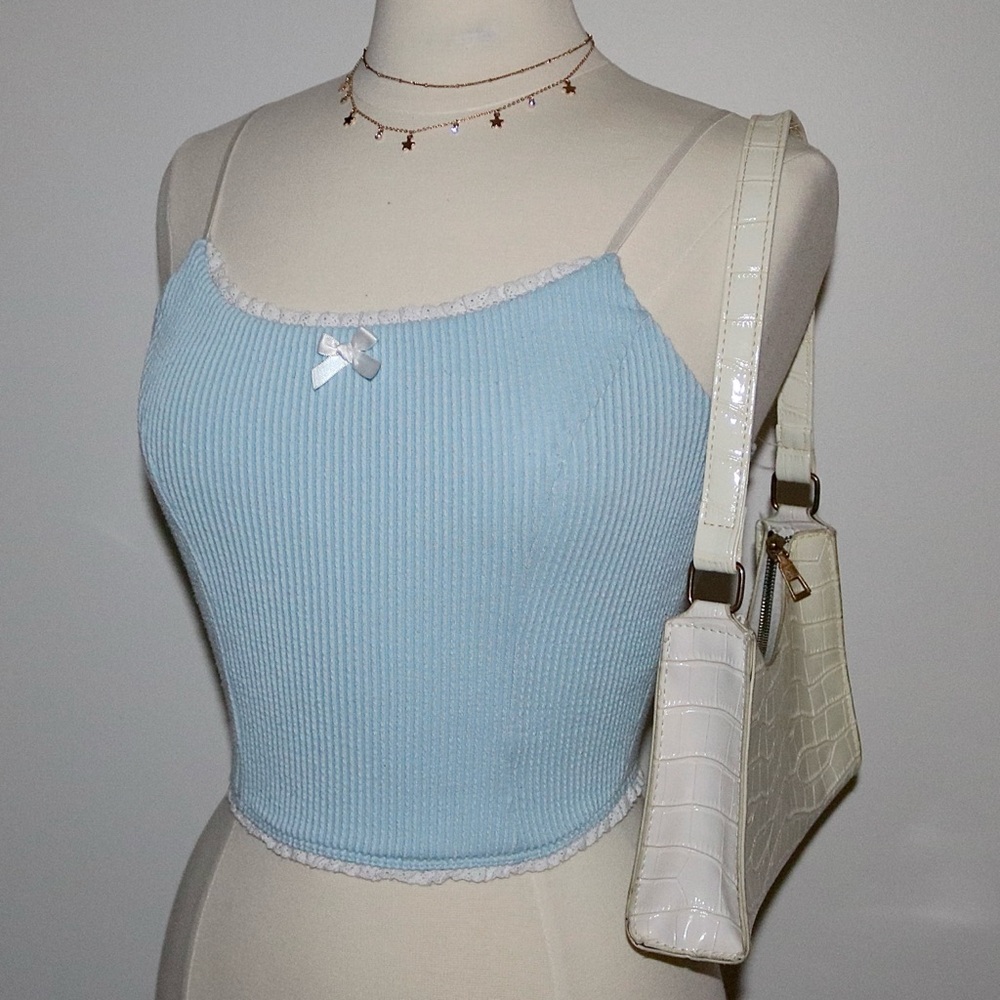 Baby blue ribbed cropped tank top with white lace trim and bow detail